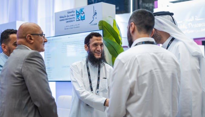 Participants at HBKU booth