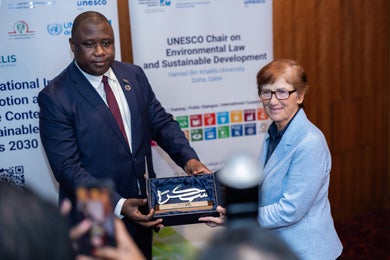 Hon. Dawda A. Jallow receives a gift from the Dean, College of Law