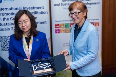 Dean, College of Law presents a gift to the representative of UNCTAD