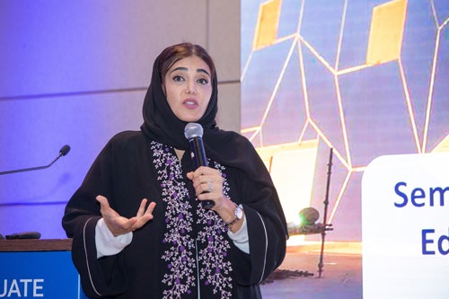 Dr. Amal Al-Malki, founding dean of the College of Humanities and Social Sciences, speaking to the attendees.