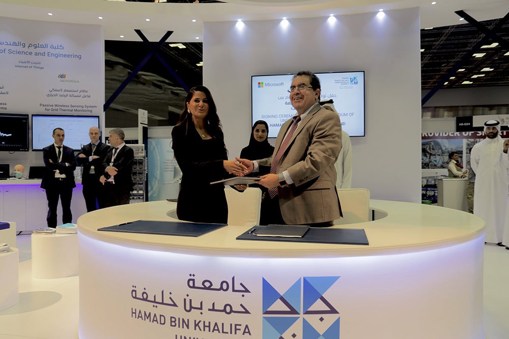 Dr. Mounir Hamdi, Dean of the College of Science and Engineering, and Lana Khalaf, Country Manager of Microsoft, officiating the HBKU-Microsoft partnership at QITCOM.