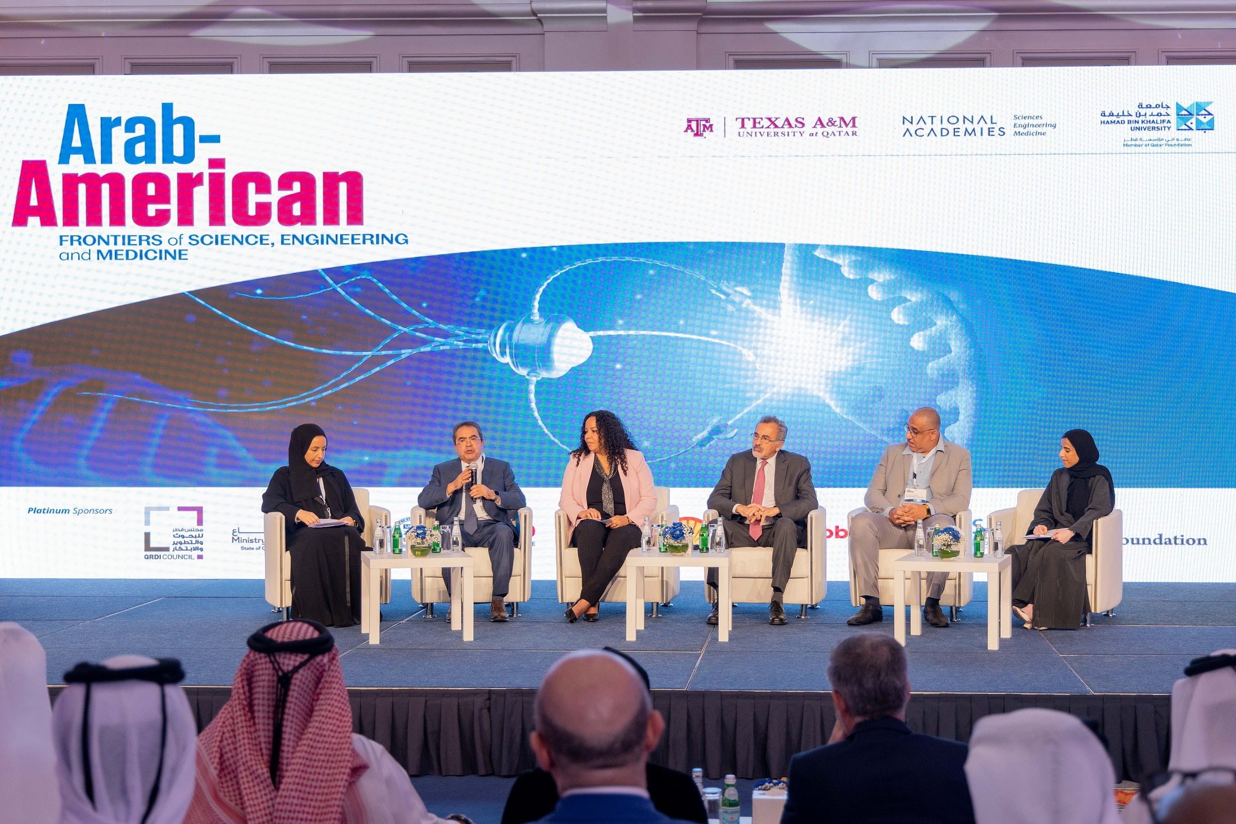 (From left) Dr. Dena Al Thani, Associate Professor, and Dr. Mounir Hamdi, Founding Dean, engage with fellow experts in one of the symposium’s sessions.