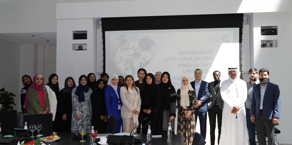 HBKU students, faculty, and staff commemorating a successful Student Research Conference alongside members of the local community.