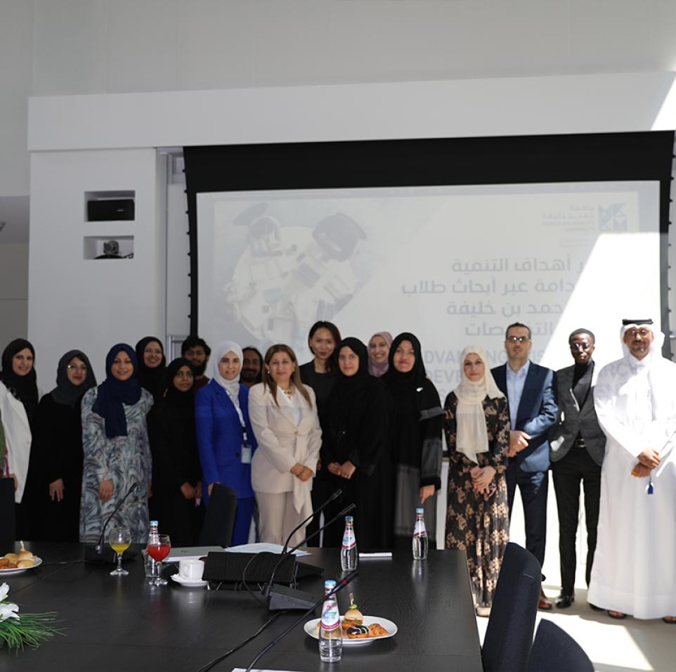 HBKU students, faculty, and staff commemorating a successful Student Research Conference alongside members of the local community.